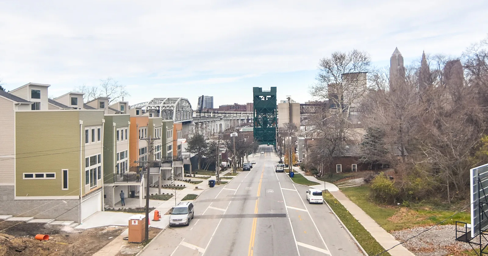 Townhouses and older homes on a street in Ohio City looking toward downtown Cleveland, illustrating the Cleveland housing market 2026 for home sellers