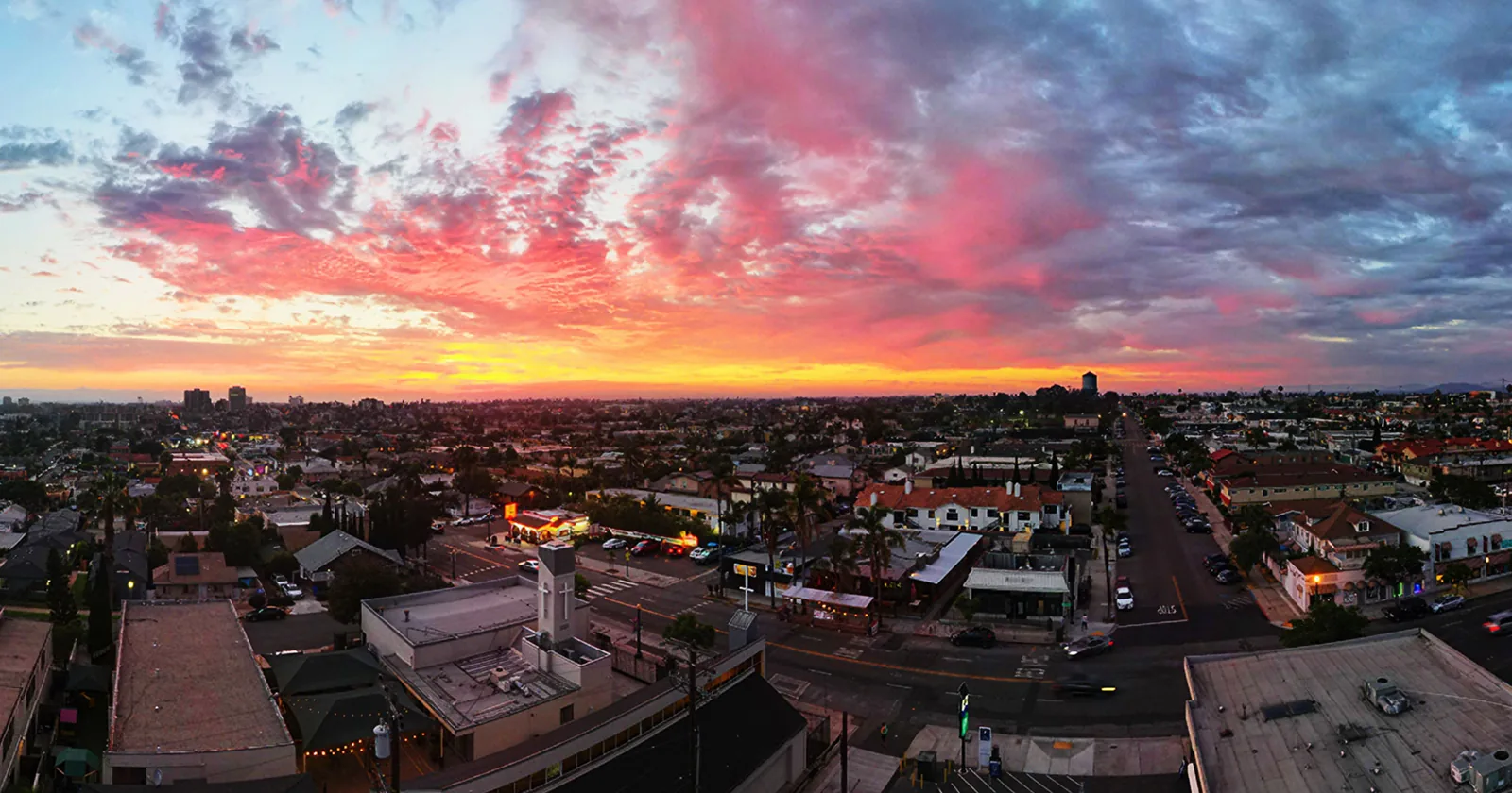 Aerial view of residential San Diego rooftops at sunset, 2026 housing market analysis for sellers