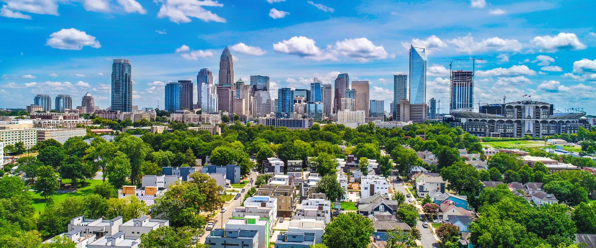 The Uptown Charlotte skyline above the tree canopy of its close-in neighborhoods