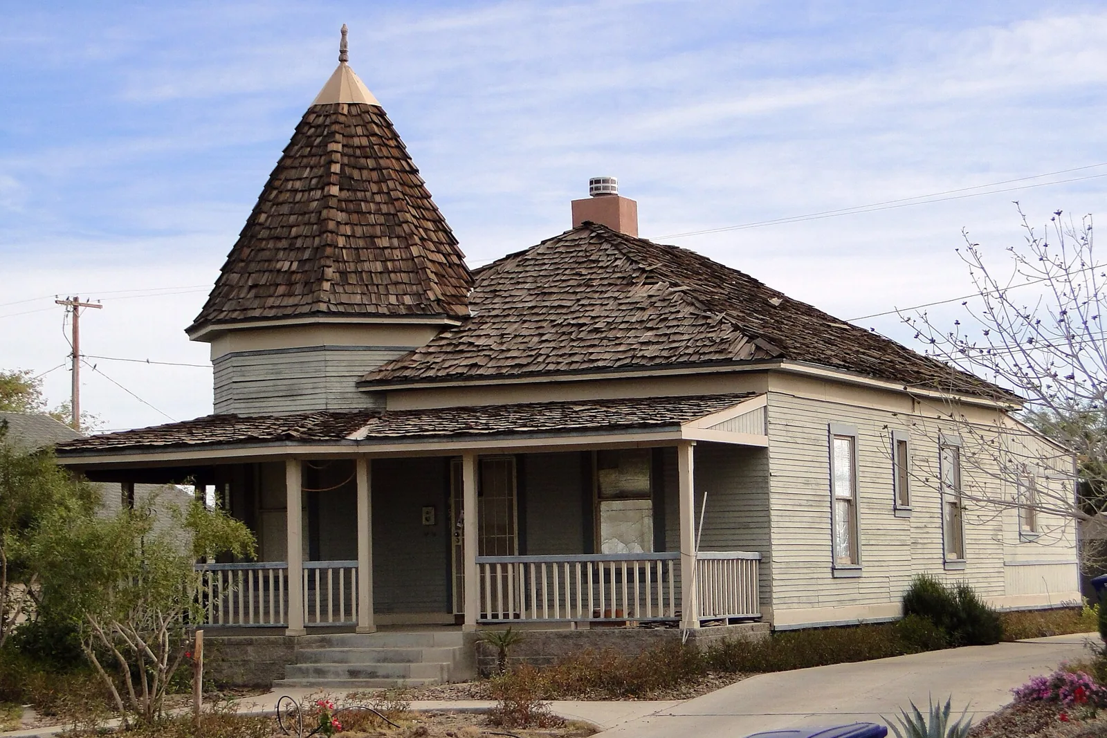 A wood-sided Queen Anne house with a shingled turret in Yuma's Century Heights Historic District