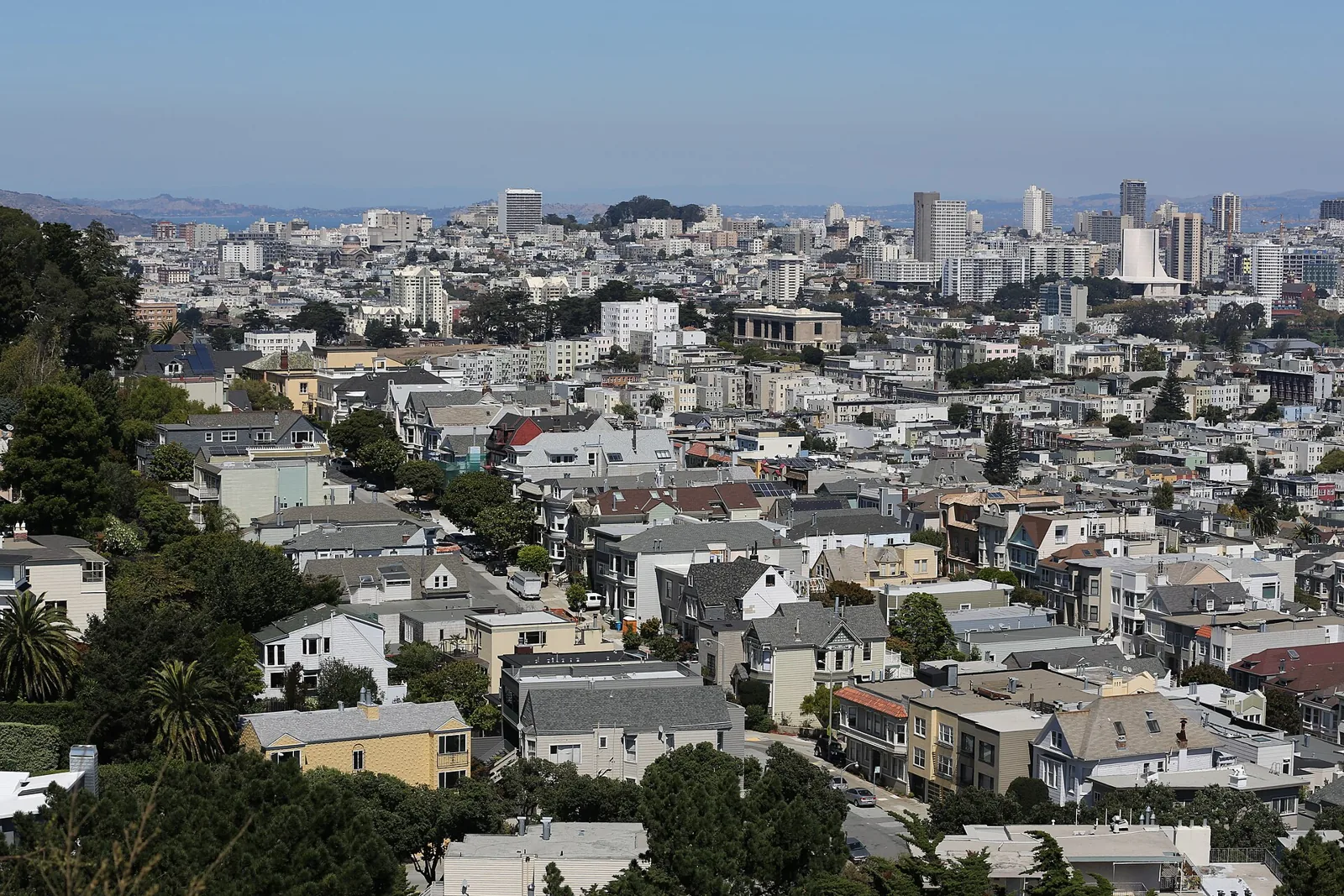 Houses and flats below Corona Heights Park in San Francisco, looking north across Buena Vista Heights and the Western Addition toward St. Mary's Cathedral on a clear afternoon