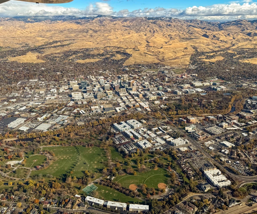 Aerial view of downtown Boise, Idaho with the foothills behind it