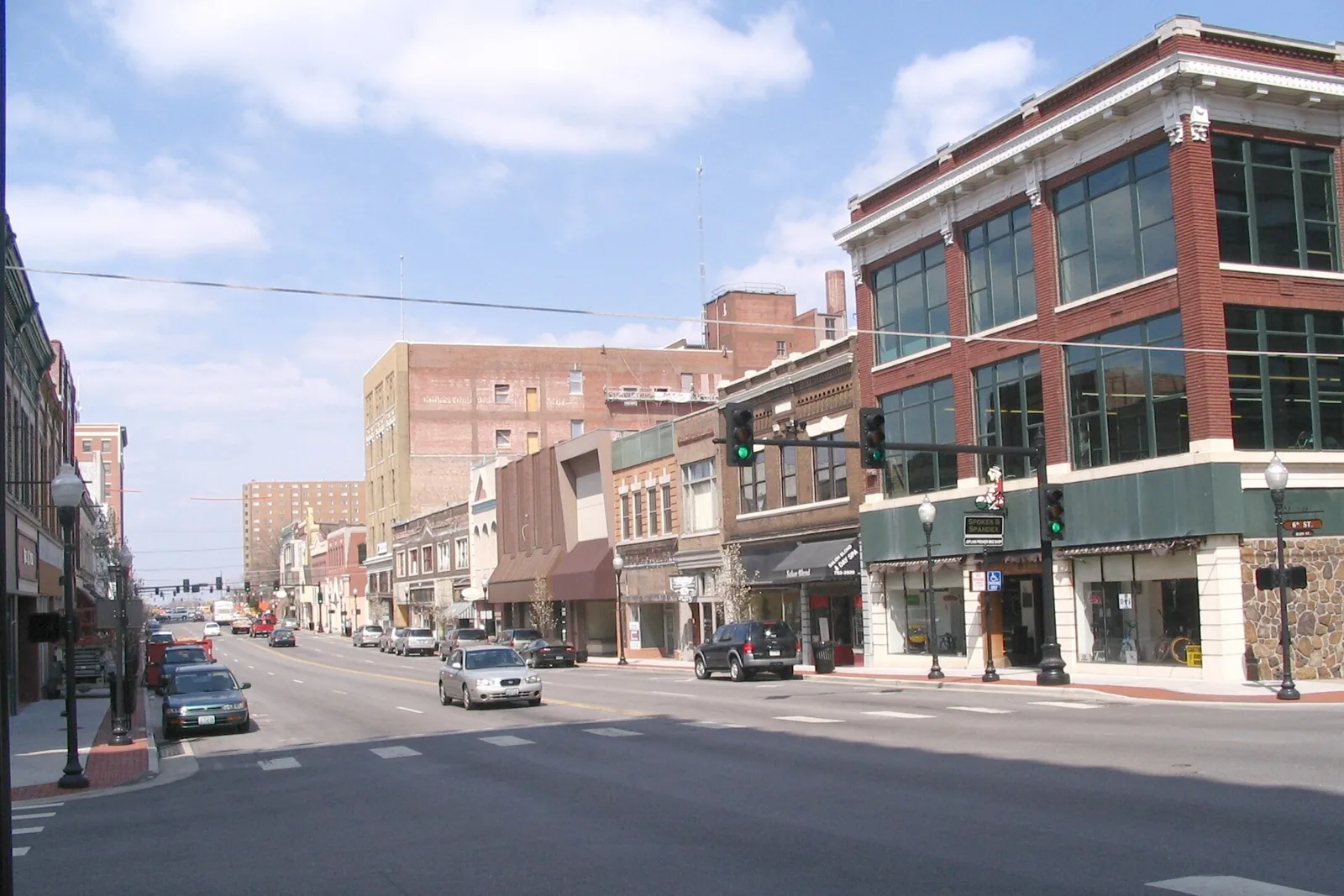 Brick storefronts and a three-story corner building line Main Street in the Downtown Historic District of Joplin, Missouri.