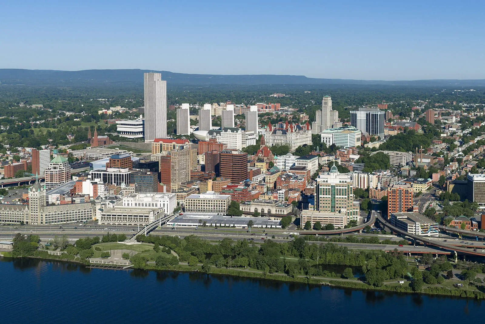 Downtown Albany and the Empire State Plaza towers seen from the air above the Hudson River on a clear summer day