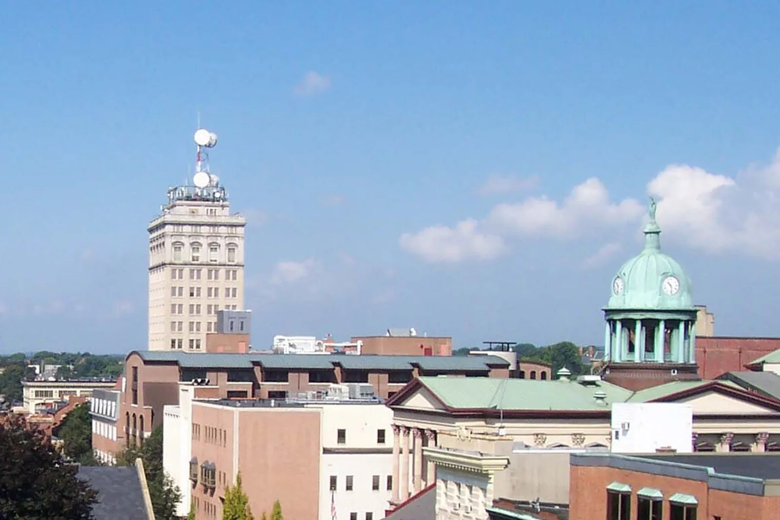 The Griest Building and the Lancaster County Courthouse dome above downtown Lancaster, Pennsylvania, under a blue sky