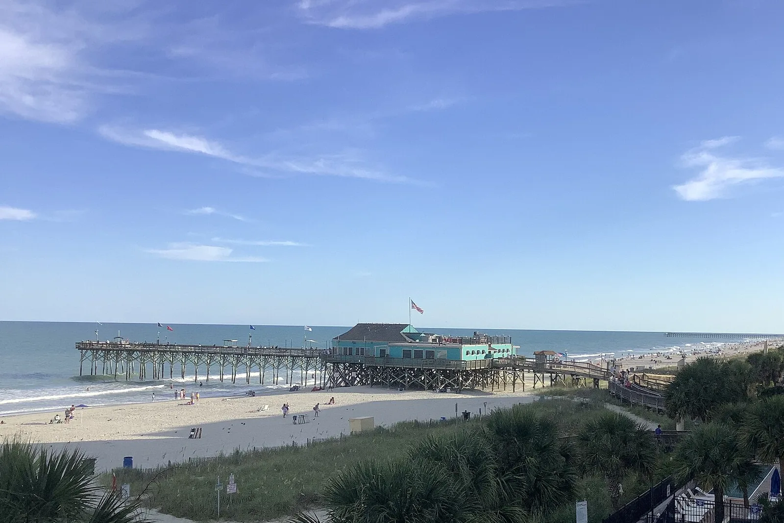 The Myrtle Beach pier and shoreline in Myrtle Beach, South Carolina, under a blue August sky