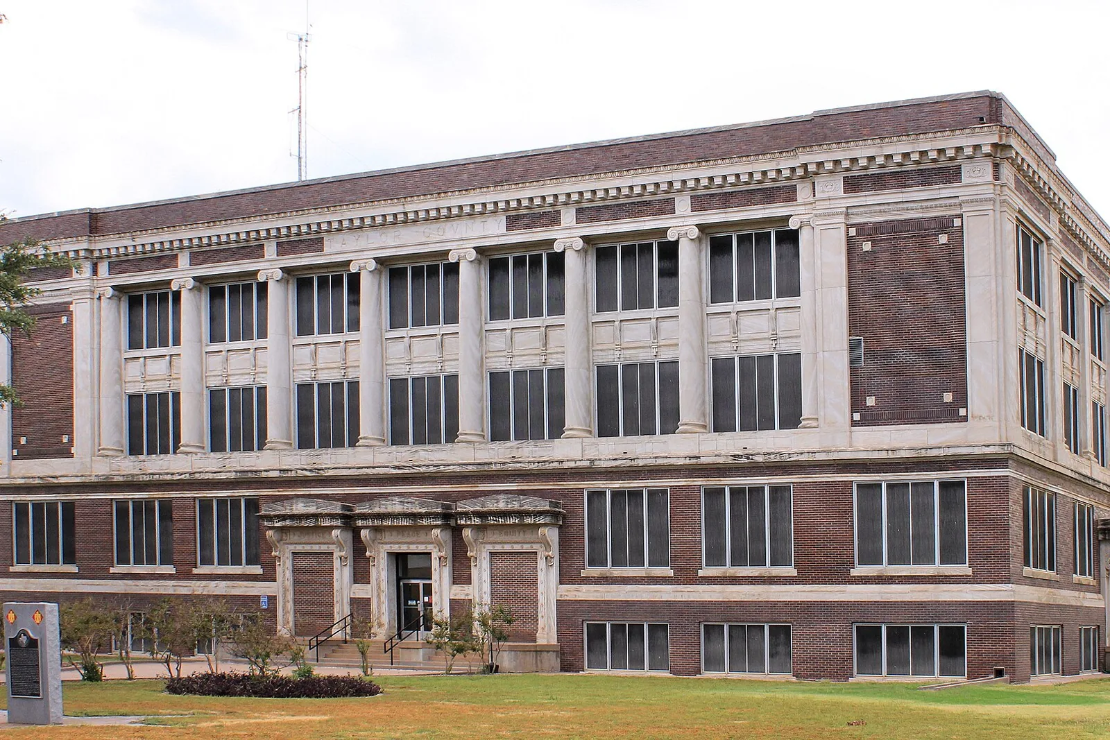 The 1915 Taylor County Courthouse in downtown Abilene, a brick building with tall marble columns above a front lawn