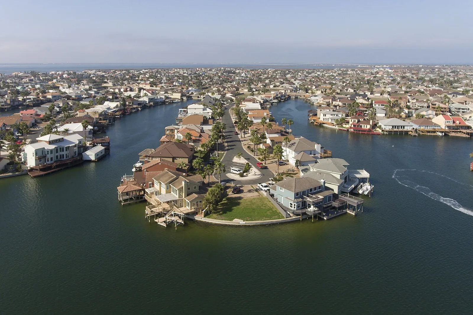 Aerial view of canal-front houses on a Padre Island cul-de-sac in Corpus Christi, with water on three sides