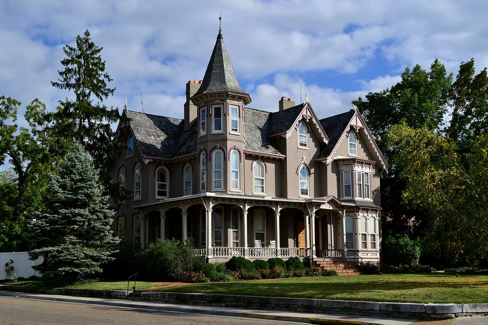 The Joshua Wilton House, a Victorian with a corner turret and wraparound porch, on South Main Street in Harrisonburg