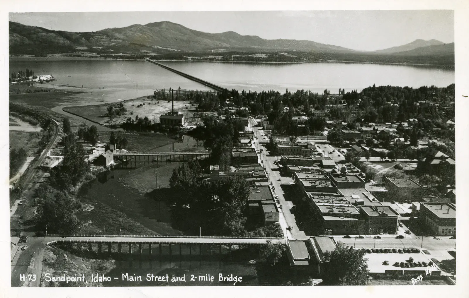 Historic view of the Sandpoint waterfront and Long Bridge on Lake Pend Oreille