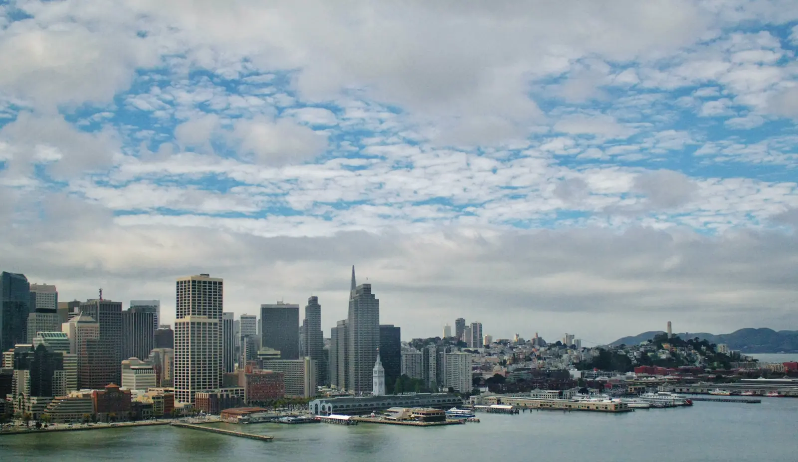 The San Francisco skyline and Bay Bridge above the South Beach waterfront