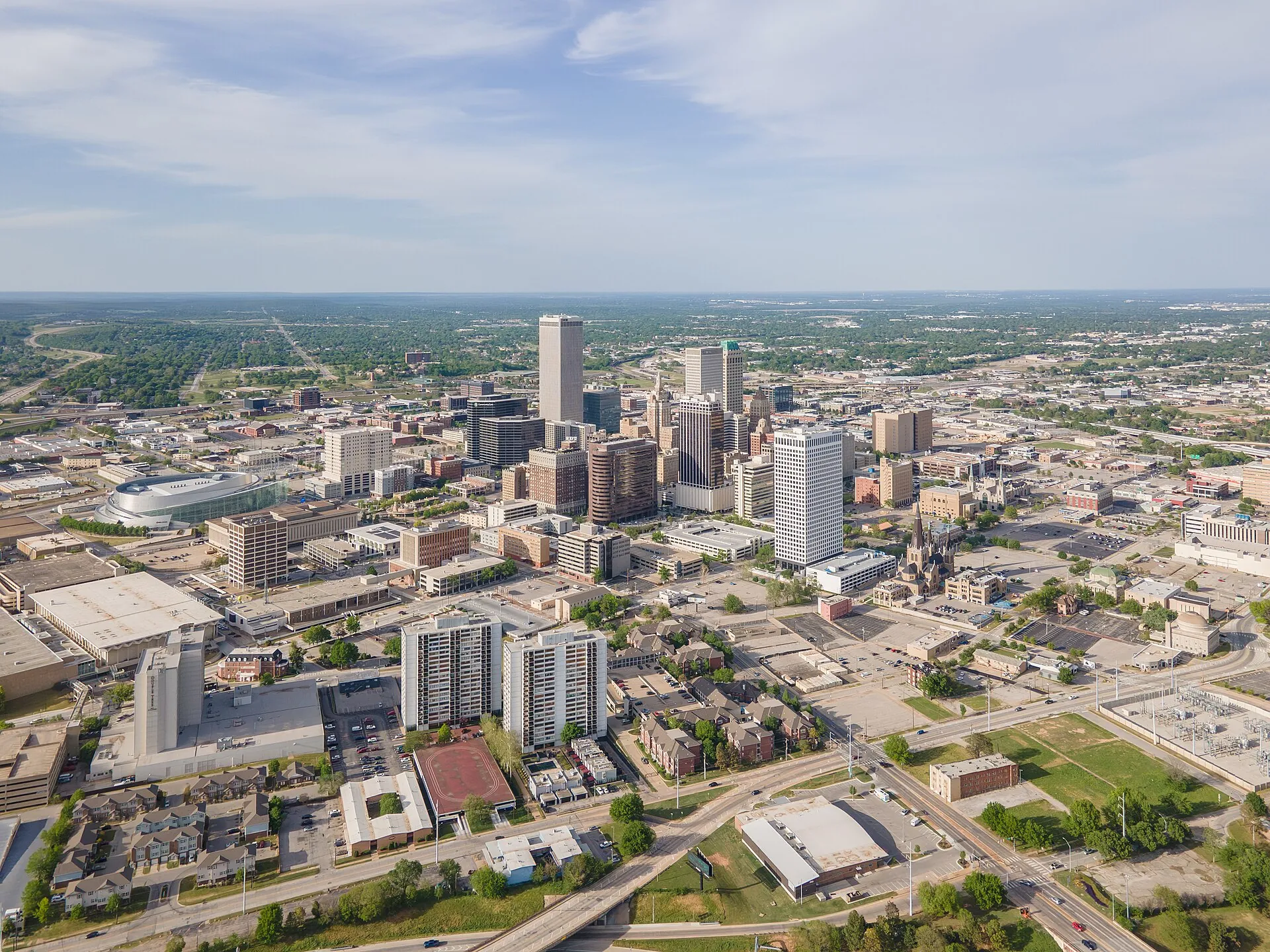 The downtown Tulsa skyline from the air, with the BOK Center at left